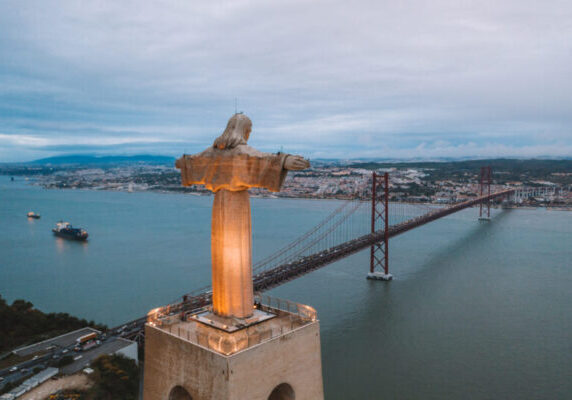 Cristo Rei Christ Statue in Lisbon in the evening time. Aerial view over Lisbon.